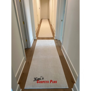Two light-colored carpet runners professionally installed on a wooden hallway floor by Kimi's Carpets Plus in Cary, NC