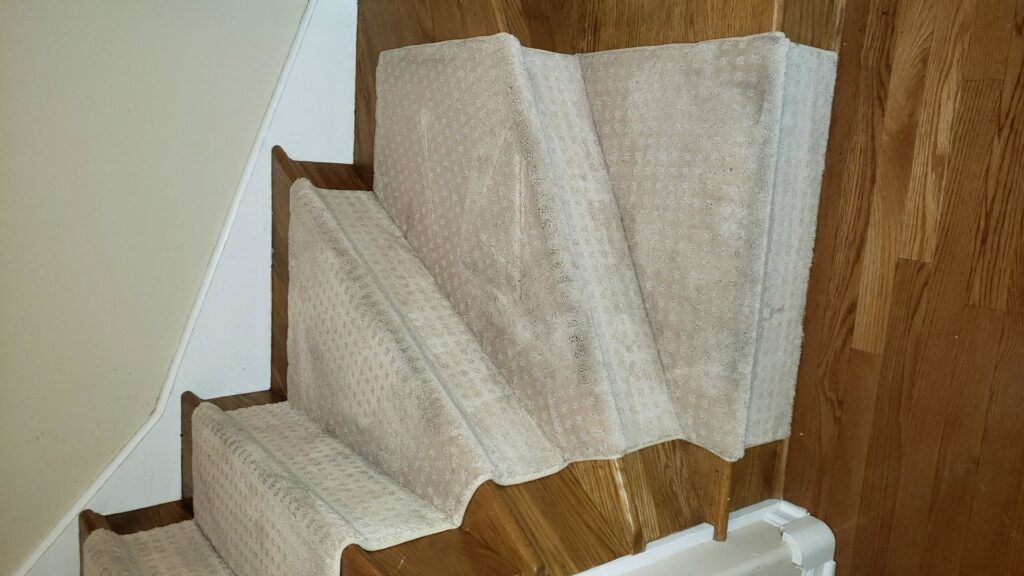 Newly installed carpet runners on wooden stairs by Anderson Certified, INC. in Chicago, IL.