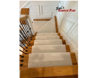 Professionally installed light-colored carpet runners on a wooden staircase by Kimi's Carpets Plus in Cary, NC