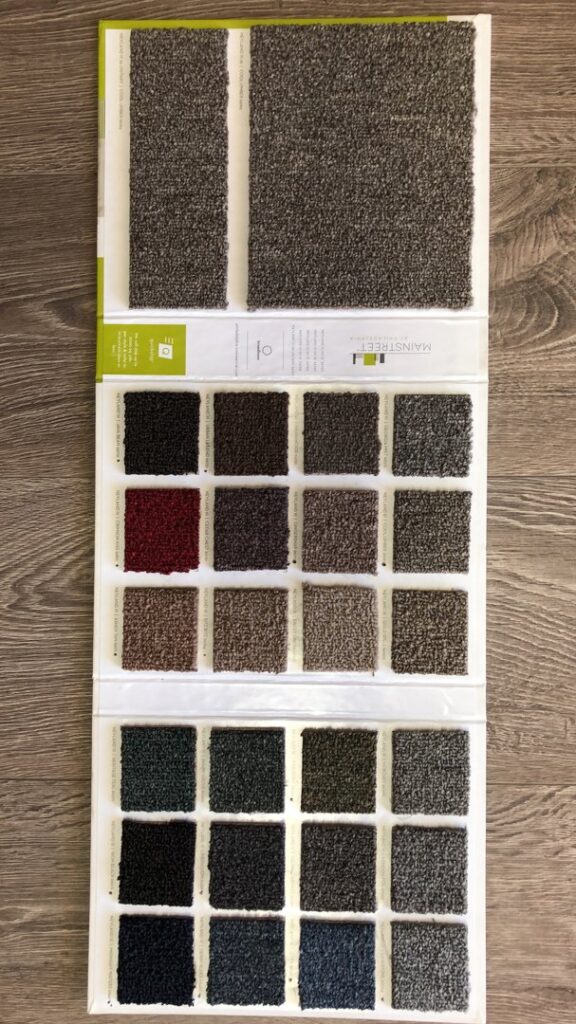 A Mainstreet carpet sample board showcasing various colors and textures from Carpets Texas in El Paso, TX.