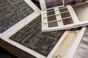 A close-up of various carpet samples in a selection book at P&Q Flooring in Johns Creek, GA.
