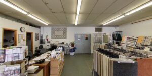 Carpet sample racks and an office area visible inside Eatherton's Fashion Floors showroom in St. Louis, MO.