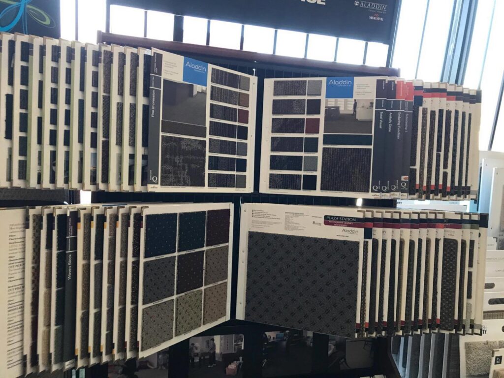 Display racks filled with various carpet samples at The Carpet Plaza in Bakersfield, CA