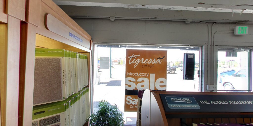 Racks filled with various carpet samples visible through the window of Westcraft Flooring's showroom in Denver, CO.