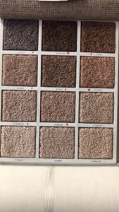 A display board showcasing various carpet samples and textures from Carpets Texas in El Paso, TX.