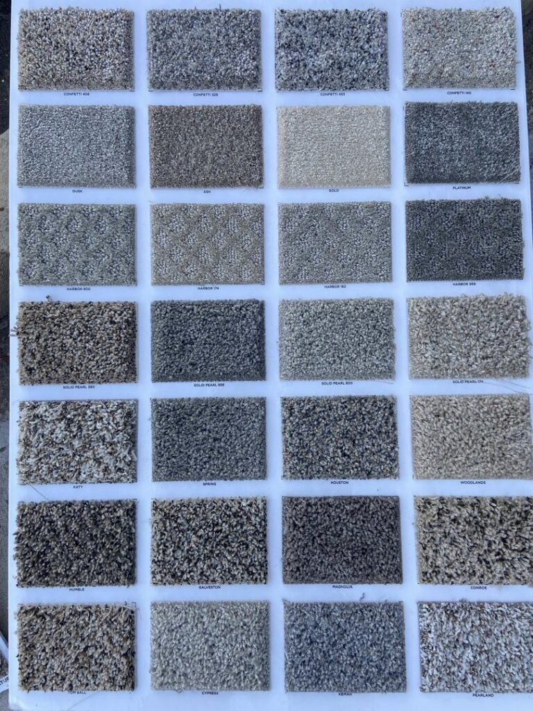 A display board showcasing various carpet samples and textures available at Castro's Carpet in Houston, TX.
