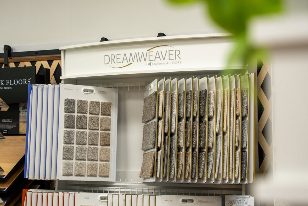A showroom display of Dreamweaver carpet samples at Grain Design Flooring in Florence, KY.