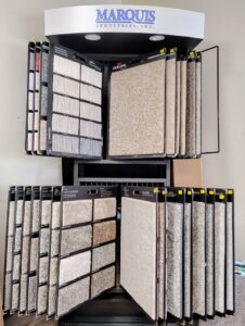 A display rack showcasing various carpet samples for selection at Floors To Go in Lighthouse Point, FL