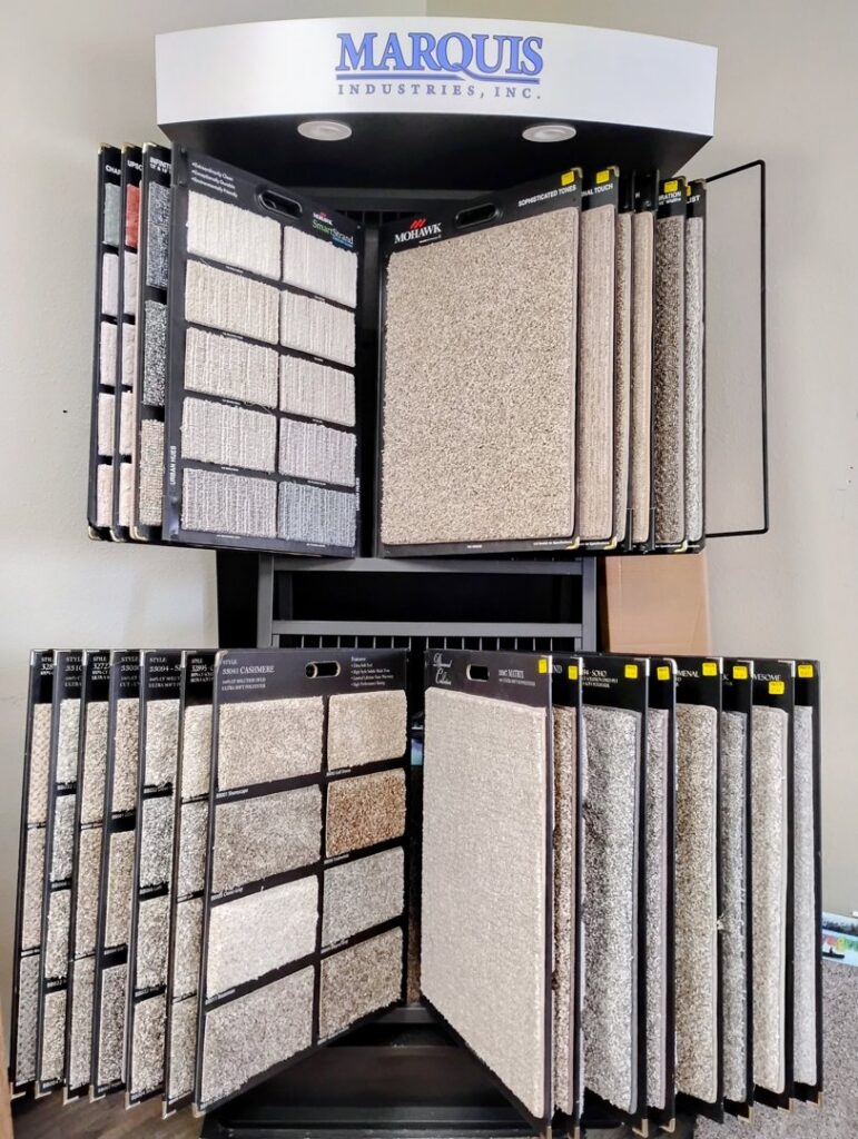 A display rack showcasing various carpet samples for selection at Floors To Go in Lighthouse Point, FL