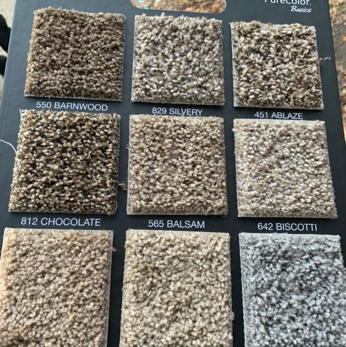 A display board showing various carpet samples for selection at HK Carpet Doctors in Sterling Heights, MI
