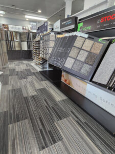 A showroom display featuring a wide selection of carpet samples and a carpeted floor at Jerry's Carpet Sales and Service in York, PA.