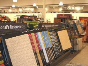 Close-up of various carpet samples on display racks inside the ProSource Flooring Kitchen & Bath showroom in Naperville, IL.