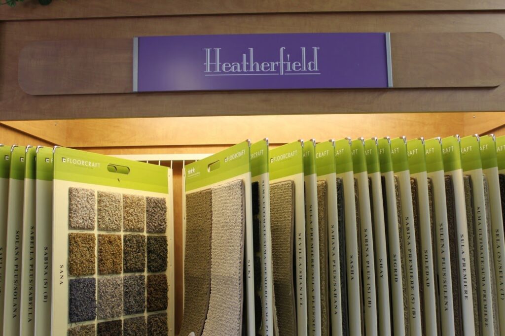 A close-up view of various carpet samples displayed on racks in the Westcraft Flooring showroom in Denver, CO.