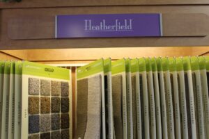 A close-up view of various carpet samples displayed on racks in the Westcraft Flooring showroom in Denver, CO.