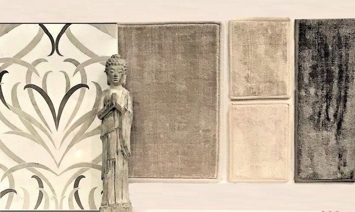 A display of various carpet samples next to a decorative statue at Adda Carpet and Flooring in New Orleans, LA.