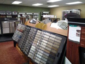 A wide selection of carpet samples displayed in the showroom of 3D Flooring & Design in Mansfield, TX