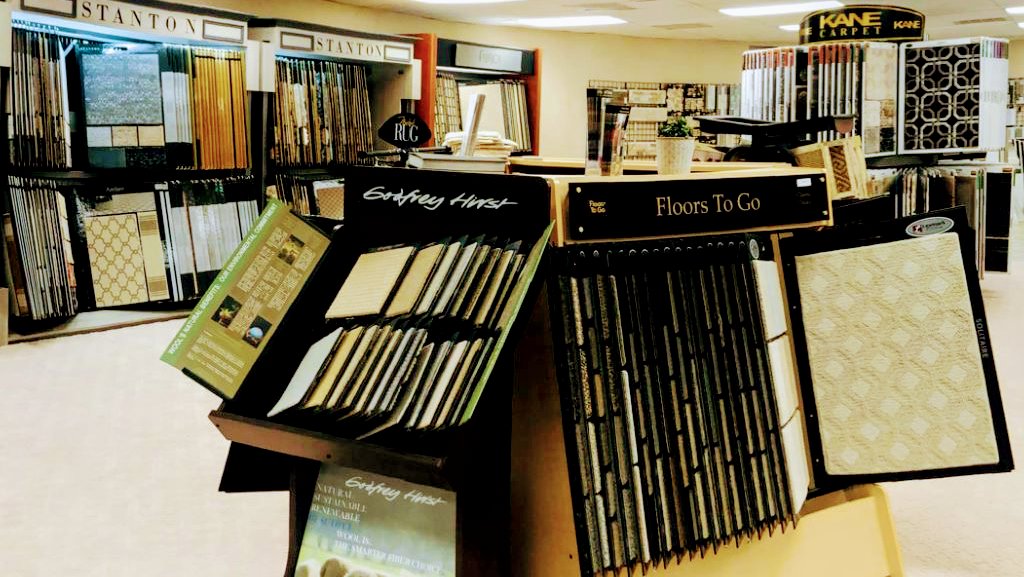 A wide selection of carpet samples displayed in the showroom at All Surfaces Wholesale in Houston, TX.