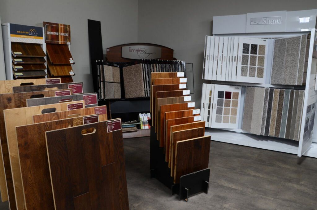 A showroom display featuring various carpet samples at BG Hardwood Direct in Bowling Green, KY