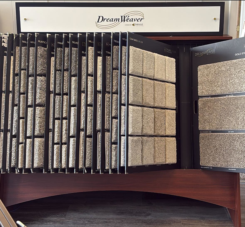 A display rack showcasing various carpet samples in the showroom at Bigger's Complete Floor Covering in Owosso, MI.