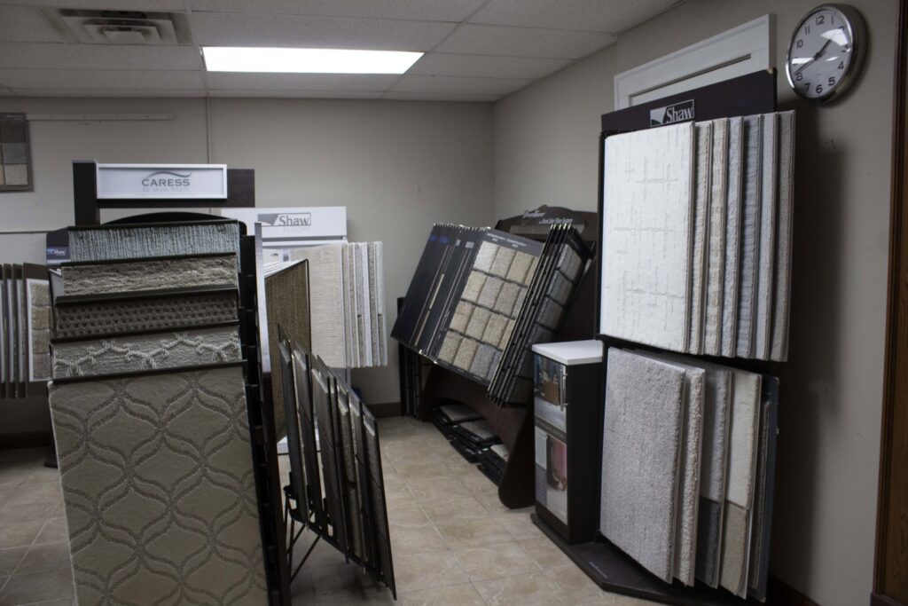 Various carpet samples displayed in the showroom of Infinite Floors Kitchens Bathrooms in Burnsville, MN