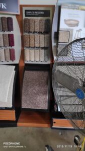 A showroom display featuring various carpet samples and textures at Dunedin Floors & Granite in Tampa, FL.