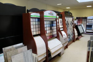 A showroom display featuring various carpet samples and styles at Paul White Company in Portland, ME.