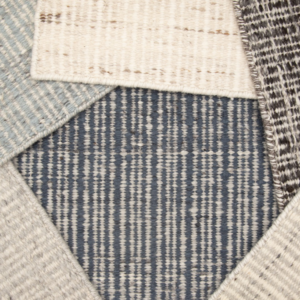 Close-up of various carpet samples with different patterns and textures at Carpet World Fargo, ND