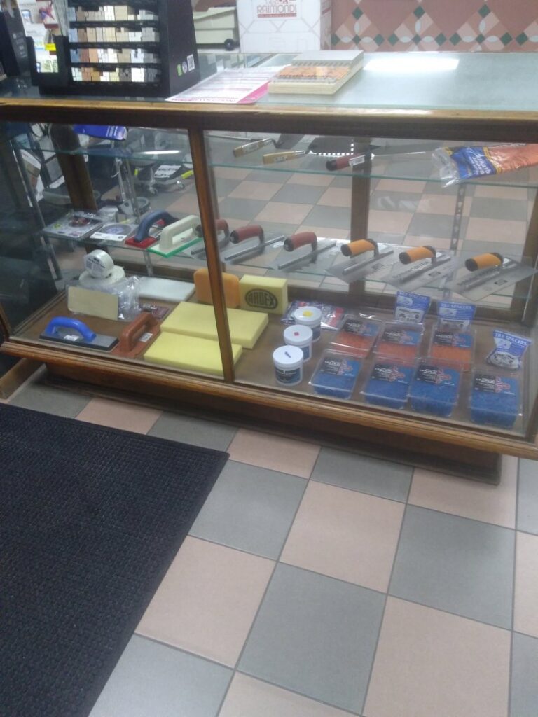 A view of the carpet section within the Palmetto Tile Columbia showroom in Columbia, SC, with tile samples in the foreground.
