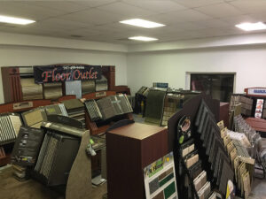 An interior view of the carpet showroom displaying various carpet rolls and samples at 1 in ALL GC in Virginia Beach, VA.
