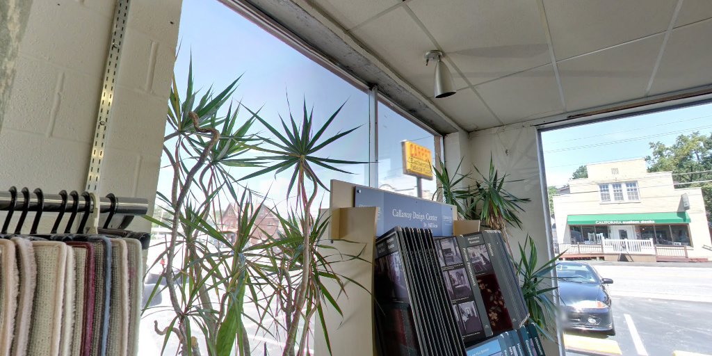 Interior view of the carpet showroom with sample racks and plants at Eatherton's Fashion Floors in St. Louis, MO.