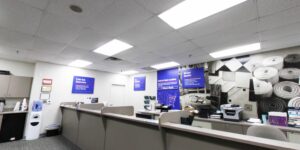 Reception area of ProSource Memphis showroom with carpeted floor and wall graphic of rolled carpets in Bartlett, TN.