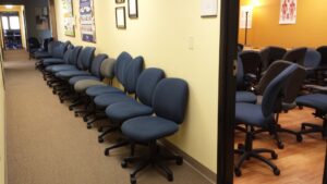 A technician using a UV light to detect hidden stains on a carpet, part of the cleaning process by Foothills Steam Carpet Cleaners in Fort Collins, CO.