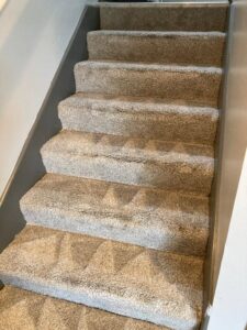Professional carpet cleaning service performed on a staircase by Master Green Cleaning in Overland Park, KS.