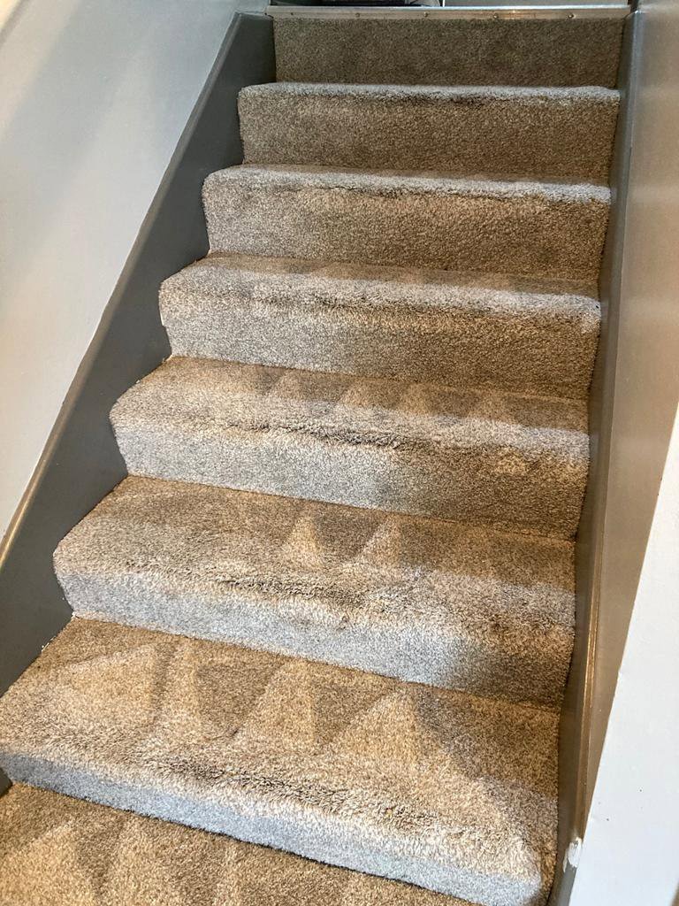 Professional carpet cleaning service performed on a staircase by Master Green Cleaning in Overland Park, KS.