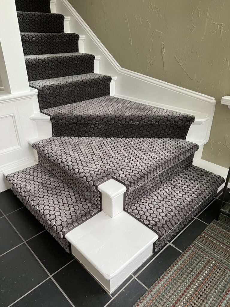 A newly installed patterned carpet stair runner by Vogel's Carpet & Flooring in Seattle, WA