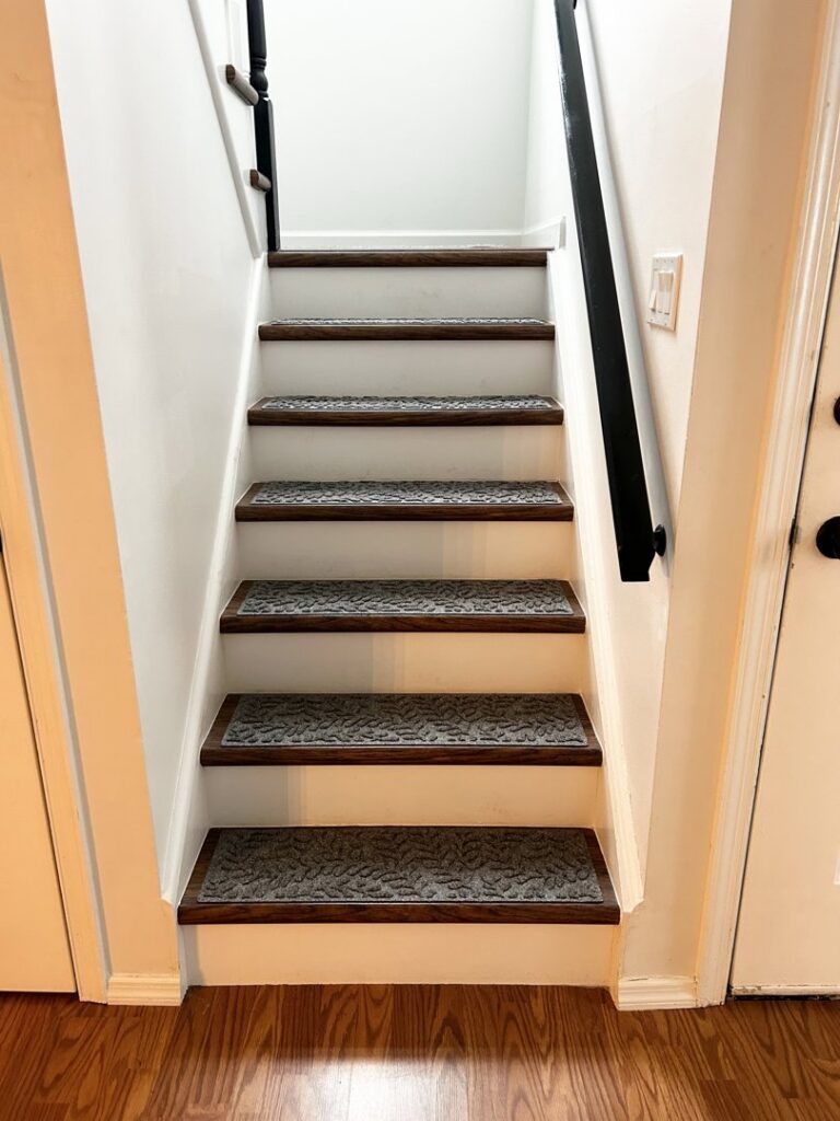 Newly installed grey carpet stair treads on a wooden staircase by J & M Flooring Supply in Lakewood, NJ.