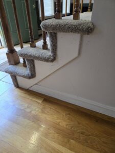 Detailed view of a carpeted staircase installation by Essex Companies LLC in Salem, NH.
