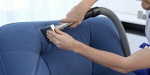 A professional performing carpet steam cleaning with a wand, showing steam rising from the carpet by Alpine Carpet Care in Medford, OR.