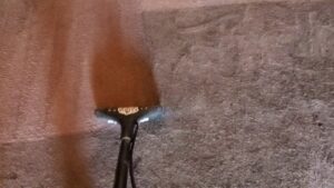 A carpet steam cleaning tool in action, showing the cleaning process by Tampa Steam Team in Plant City, FL.