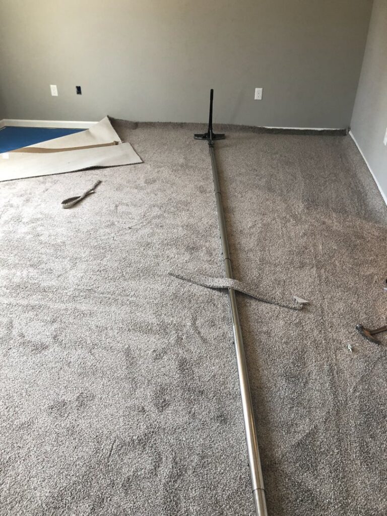 Carpet stretching and installation in progress with a power stretcher tool, performed by S&H Floor Covering in Cross Junction, VA.