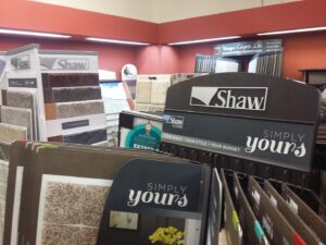 Close-up of various carpet swatch samples on display racks at Discount Carpet Brokers in Scottsdale, AZ