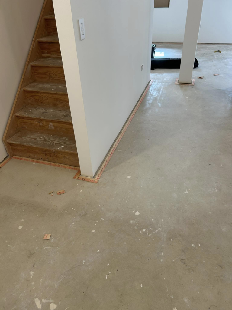 Carpet tack strips installed on a concrete floor, preparing for new carpet installation by Creative Carpet Solutions LLC in Houston, TX.