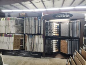 A display unit showcasing various carpet and tile options from CarpetsPlus Colortile in Swansea, MA