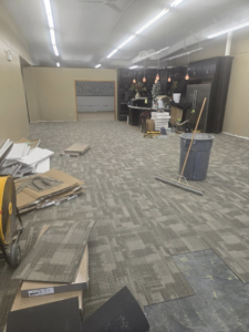 Carpet tile installation in progress at a commercial property by Centennial Carpet & Flooring in Mitchell, SD.