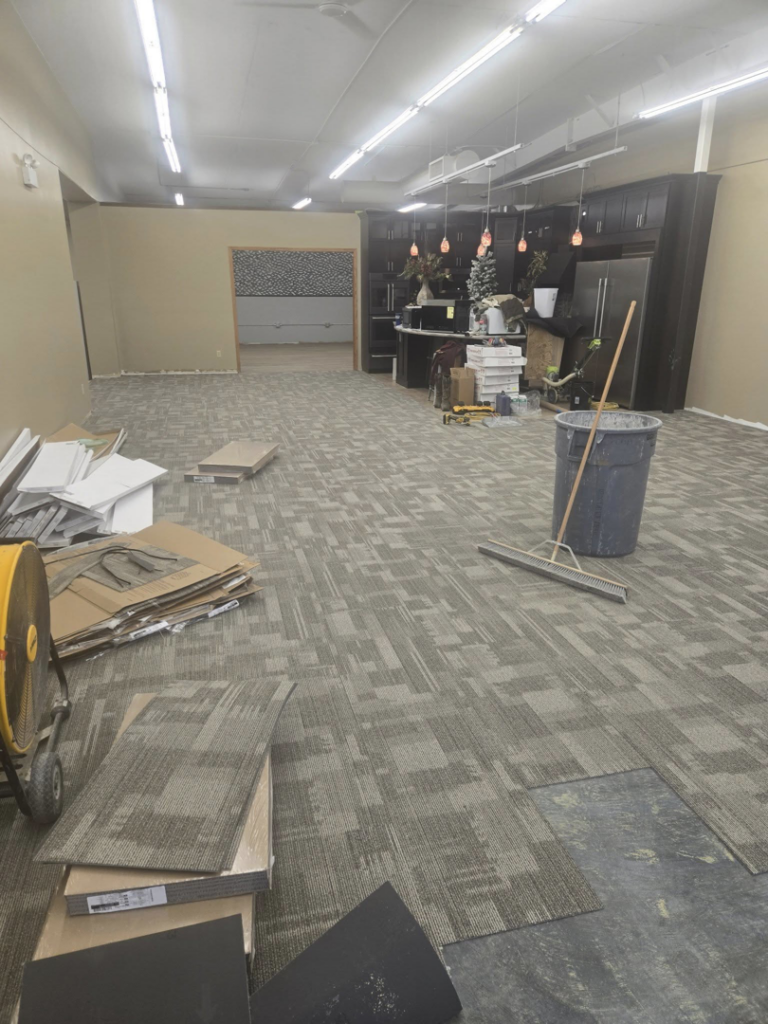 Carpet tile installation in progress at a commercial property by Centennial Carpet & Flooring in Mitchell, SD.