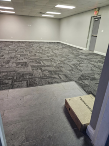 Carpet tile installation transitioning to a tiled entrance by JB'S floor covering in Semmes, AL