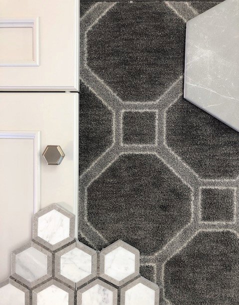 Close-up of a carpet sample with tile and cabinet materials for design selection at Adda Carpet and Flooring in New Orleans, LA.