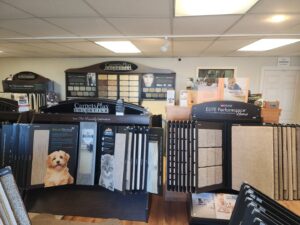 Carpet and tile sample displays with CarpetsPlus Colortile branding in Swansea, MA