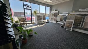 Interior view of a flooring showroom displaying various carpet tile samples at Carpets Direct Naperville, IL.