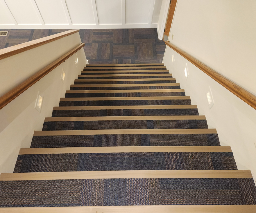 Newly installed carpet tile on stairs, showcasing a professional carpet contractor job by Flooring of Springfield in Springfield, IL.